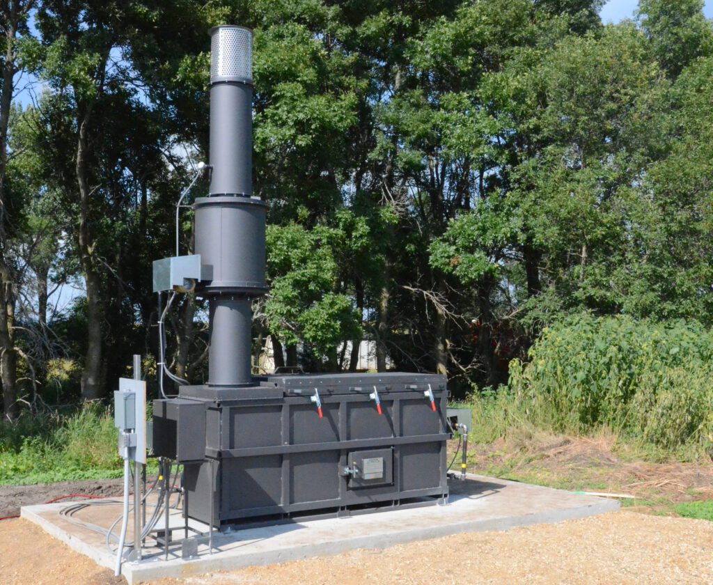 Dark gray model P77 with stack on right, sitting on cement slab